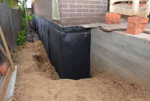 Happy homeowners after waterproofing job in Cottage Grove